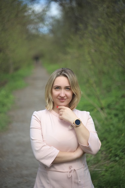 Beautiful girl stands in the park