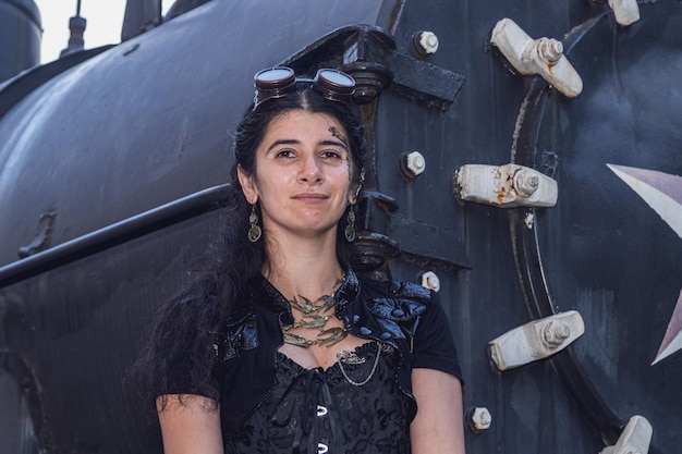 Beautiful girl in steampunk clothes on the background of the train