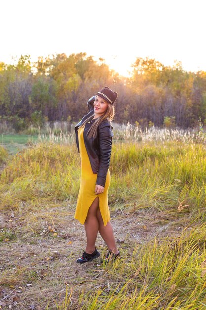 Beautiful girl on a walk in autumn sunny nature