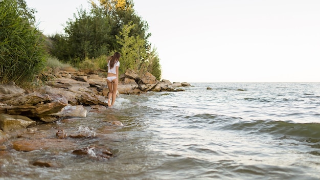 Beautiful girl walking by the sea