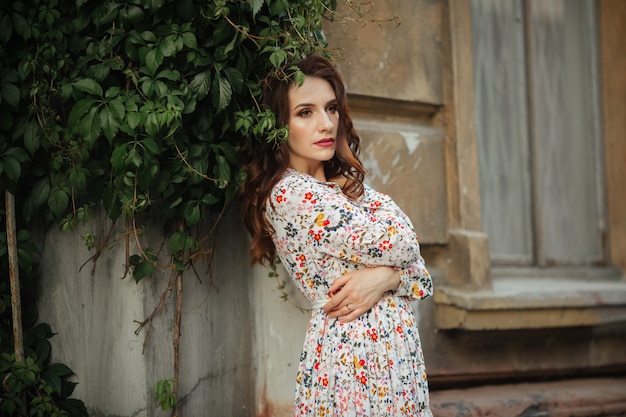 Beautiful girl walking on the street in spring. Young woman enjoying spring weather weather.