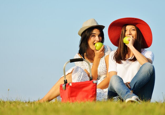 Beautiful girl wearing red hat on summer meadow