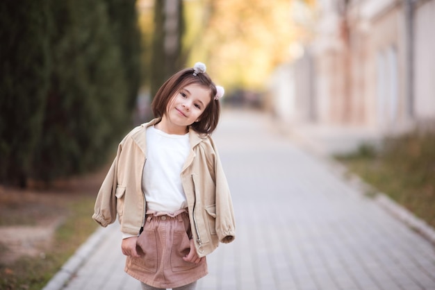 Beautiful girl wearing stylish jacket and skirt walking on street over city