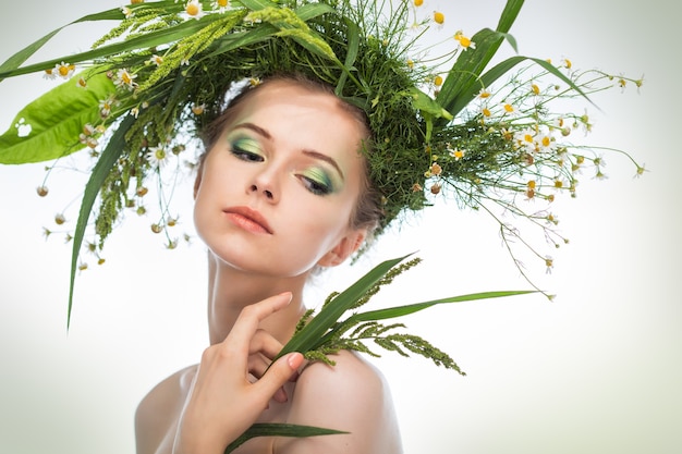 Beautiful girl wearing a wreath of wildflowers