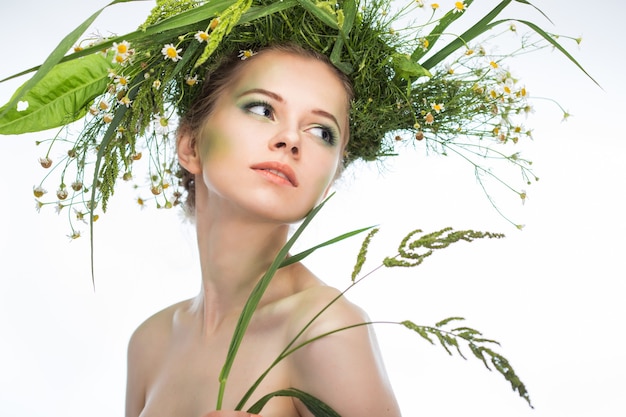 Beautiful girl wearing a wreath of wildflowers