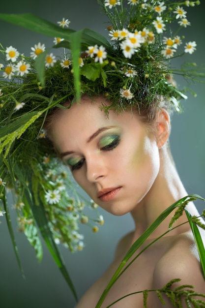 Beautiful girl wearing a wreath of wildflowers