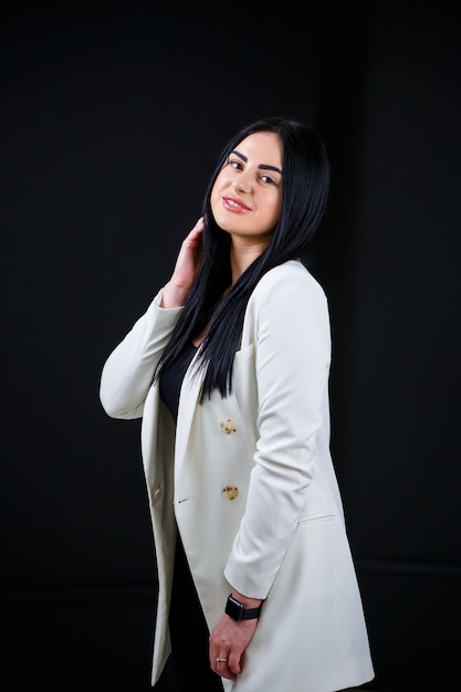 Beautiful girl in white on a black background