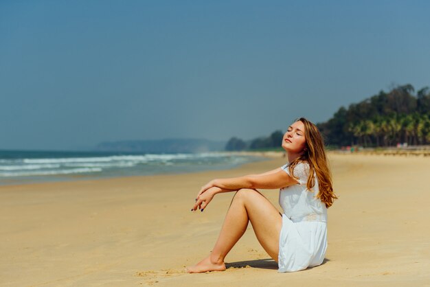 Beautiful Girl in White Dress Enjoy and Relax on The Beach. Travel and Vacation.