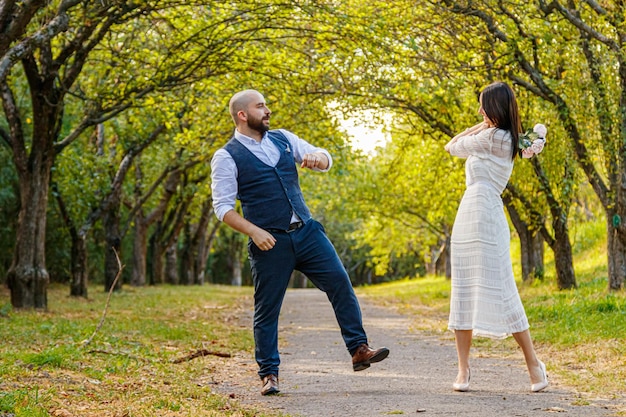 Beautiful girl in a white dress and a guy in a fruit pair