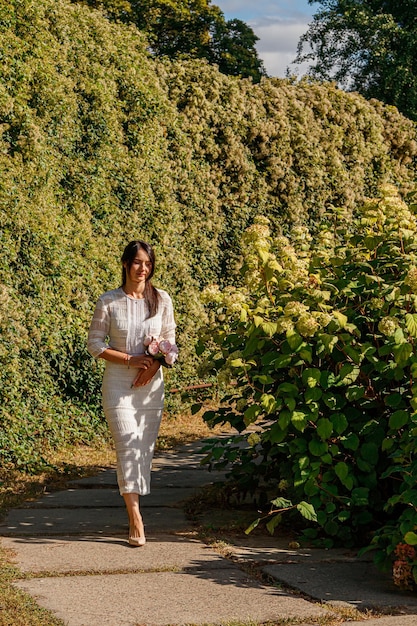 Beautiful girl in a white dress in the park