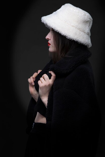 A beautiful girl in a white fur hat.