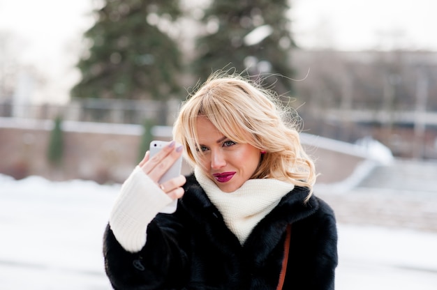 Beautiful girl winter selfie, blonde, outdoors
