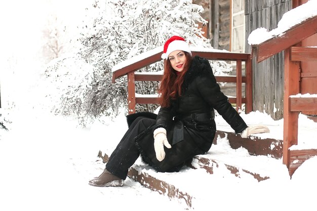 Beautiful girl in winter snowy day outdoors