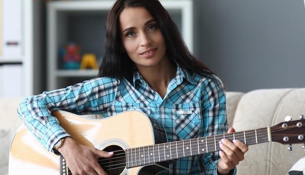 Beautiful girl with acoustic guitar in her hands