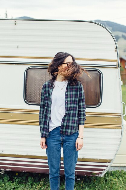 Beautiful girl with backpack traveling girl standing near
trailer traveling in mountains woman in glasses traveling by car
traveler girl thumbs up