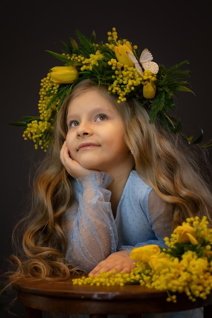 Beautiful girl with a bouquet of mimosa flowers