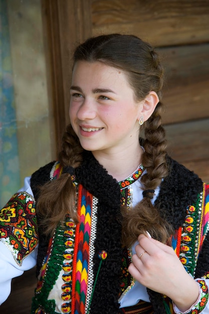 A beautiful girl with braids in national Hutsul clothes. Ukrainian national clothes.