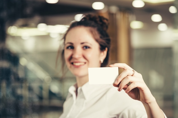 Beautiful girl with a business card.