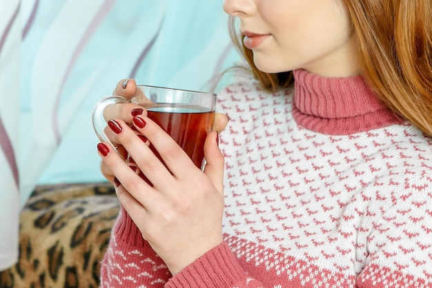 熱いお茶のカップを持つ美しい少女