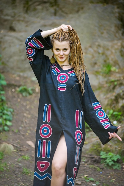 Photo beautiful girl with dreadlocks dressed hippie styleposes outdoors