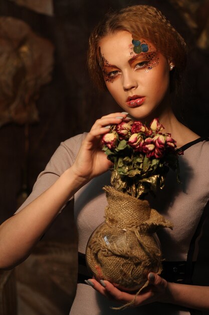 Beautiful girl with dry roses