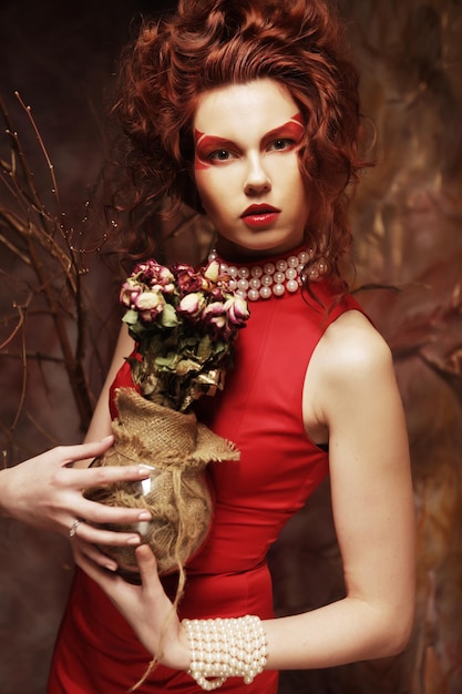 Beautiful girl with dry roses