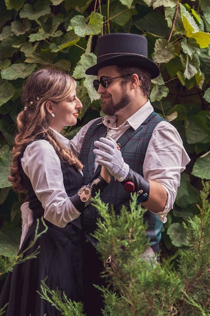 Beautiful girl with a guy couple in love in steampunk clothes