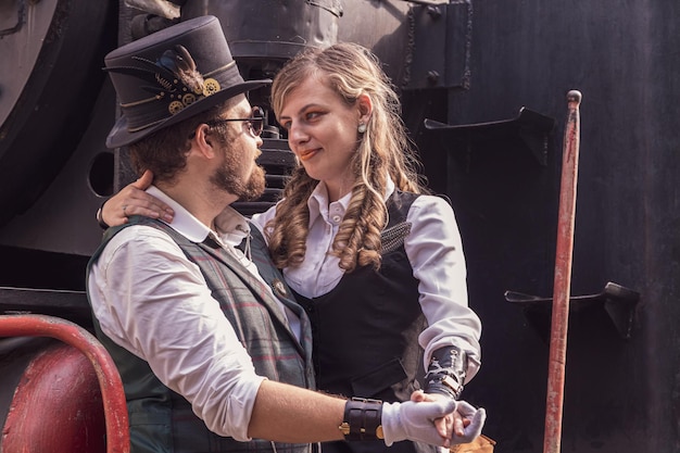 Beautiful girl with a guy couple in love in steampunk clothes