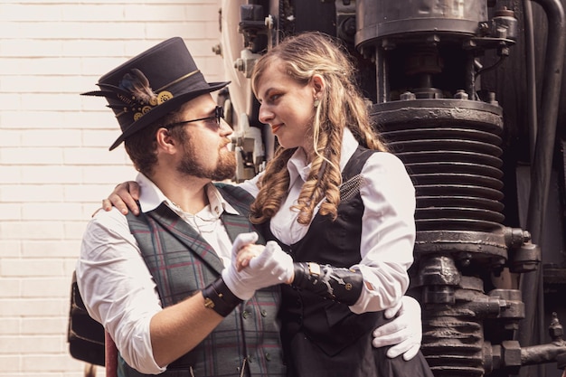 Beautiful girl with a guy couple in love in steampunk clothes