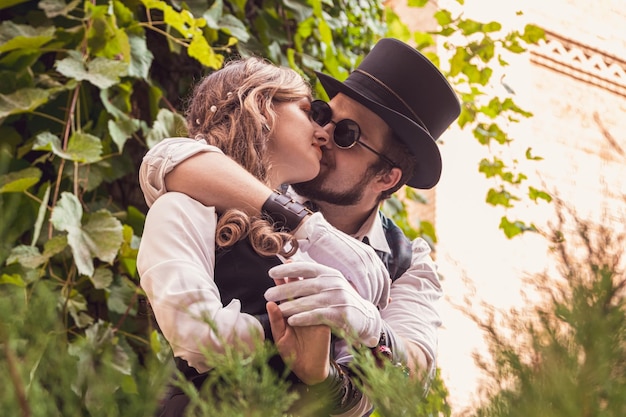 Beautiful girl with a guy couple in love in steampunk clothes