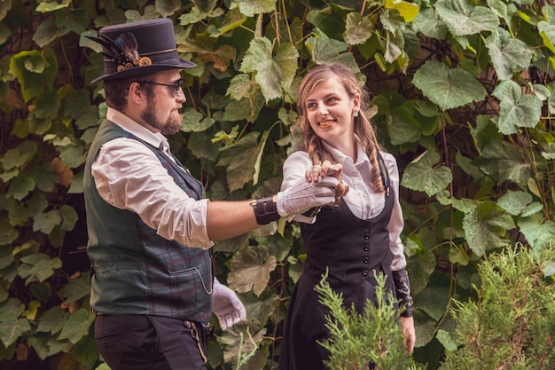 Beautiful girl with a guy couple in love in steampunk clothes