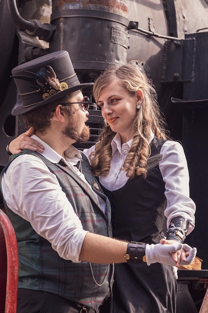 Beautiful girl with a guy couple in love in steampunk clothes