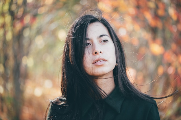 Beautiful girl with long black hair in a park