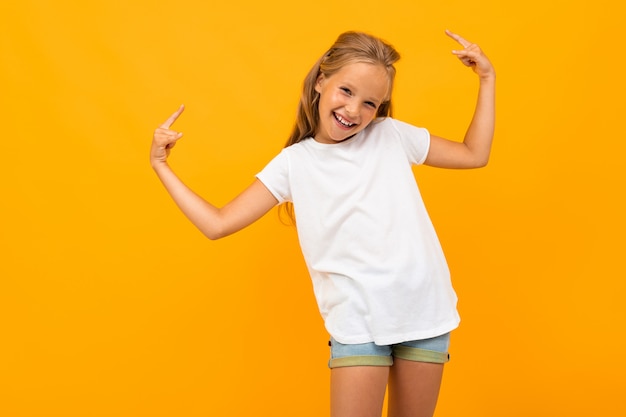 Beautiful girl with long hair smiles, picture isolated on yellow