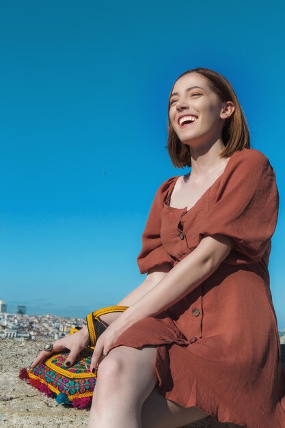 Beautiful girl with orange colored dress posing with Istanbul Scene