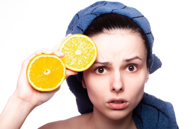 beautiful girl with oranges and a towel on her head