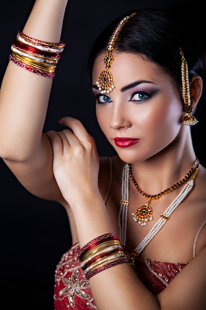 Beautiful girl with oriental makeup and Indian Jewelry, fashion look