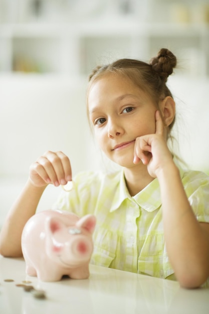 Beautiful girl with a piggy bank