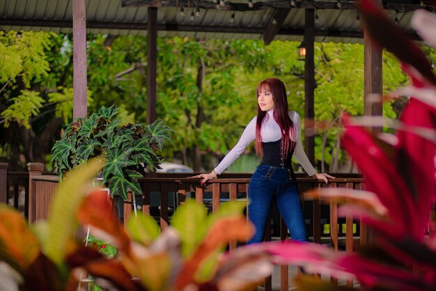 beautiful girl with red hair by a wooden fence