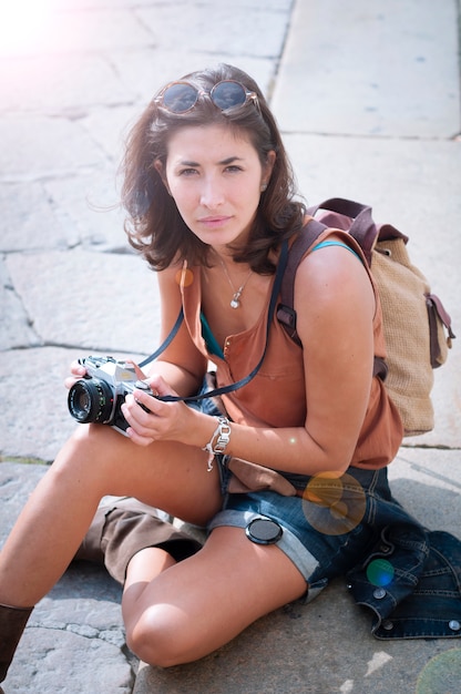 Photo beautiful girl with scarf and camera on the lawn