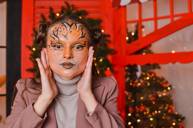 A beautiful girl with a tiger makeup New year concept Year of the tiger