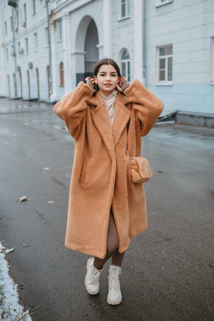 Beautiful girl woman in fur coat positive portrait