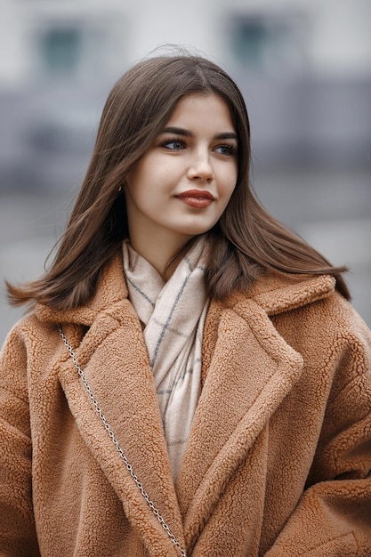 Beautiful girl woman in fur coat positive portrait