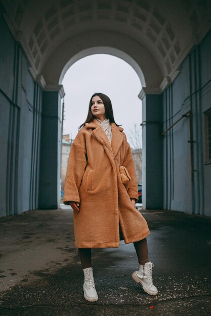 Beautiful girl woman in fur coat positive portrait