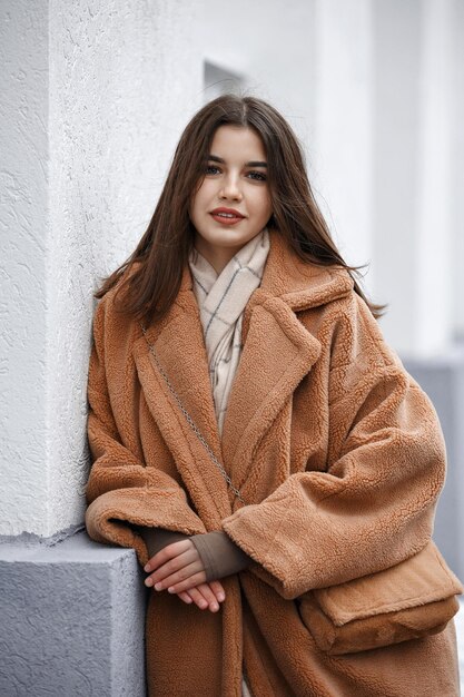 Beautiful girl woman in fur coat positive portrait