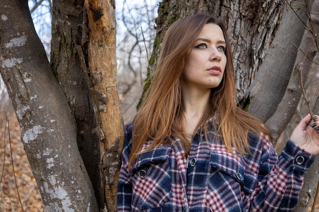 Beautiful girl in the woods near the trees