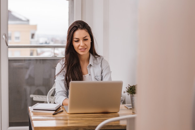 Beautiful girl working on computer at home