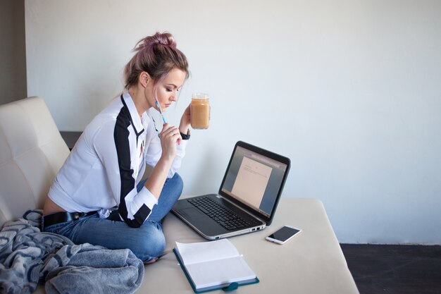 Beautiful girl working at home with laptop