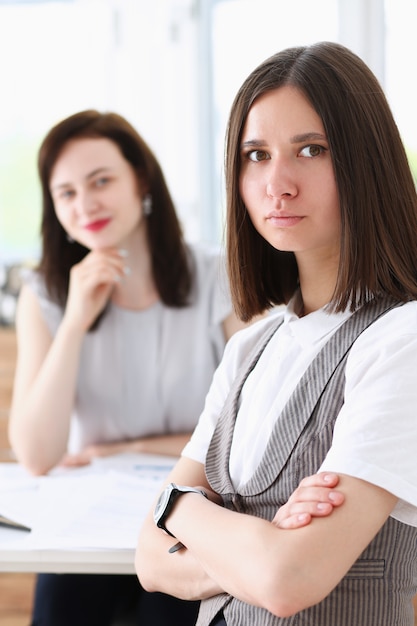 Beautiful girl at workplace with ars crossed