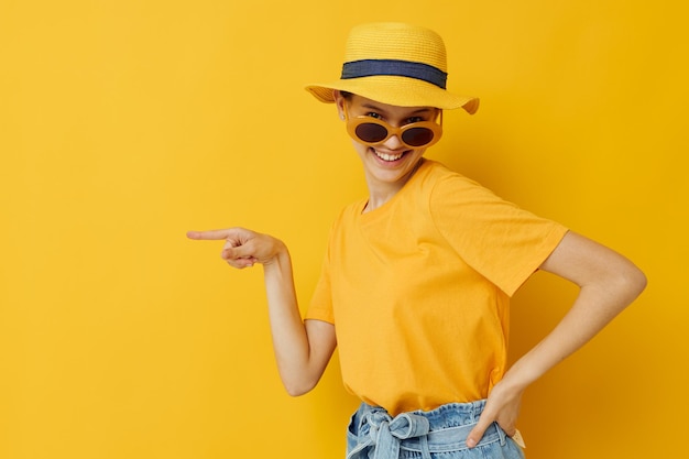 Beautiful girl in a yellow hat Youth style casual wear in sunglasses Lifestyle unaltered